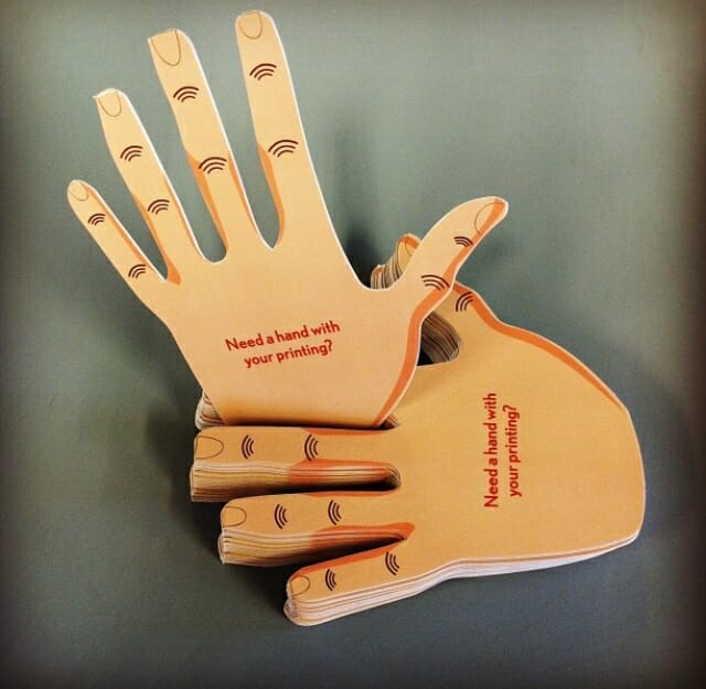 Die cut business cards in the shape of a hand
