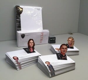 Folded and die cut business cards in the shape of a caricature