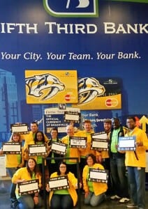 Fifth Third employees with SU2C signs at the game