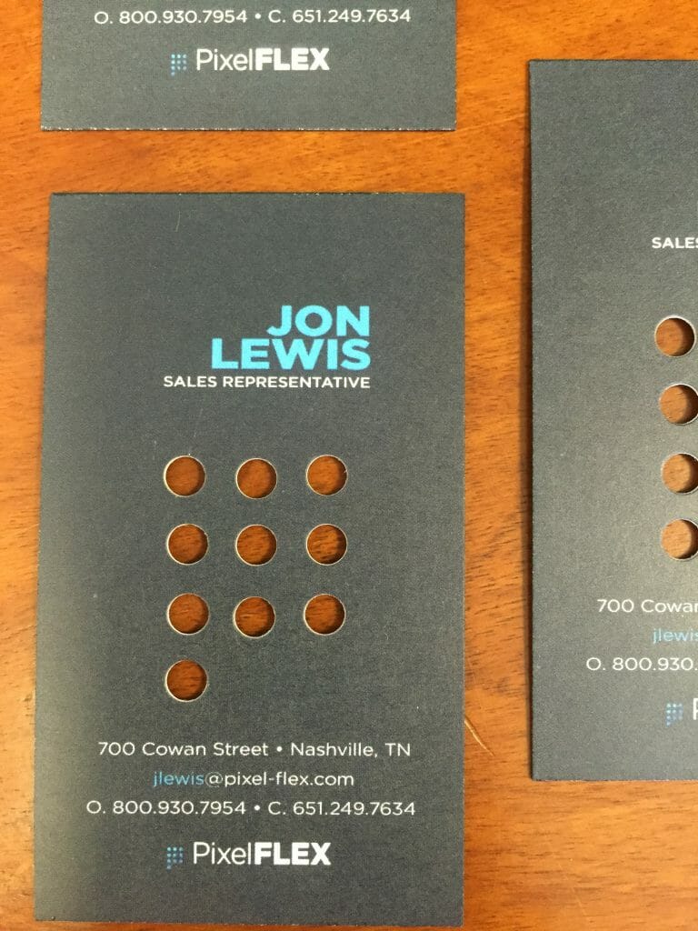  a grey pixelflex business card made for jon lewis by advocate marketing and print.